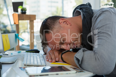 Businessman sleeping at desk in office