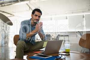 Portrait of man sitting on chair in office