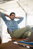 Man resting on chair in office