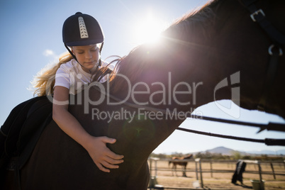 Girl climbing the horse back in the ranch