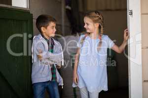 Boy and girl smiling at each other in the stable