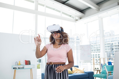 Female executive using virtual reality headset