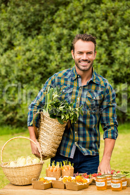 Portrait of smiling handsome man selling organic vegetables