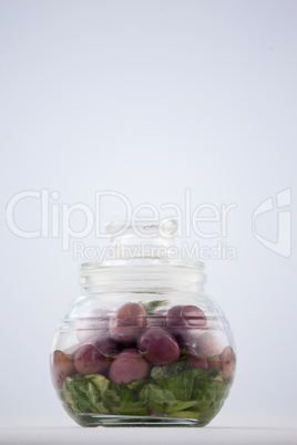 Close up of red olives in jar