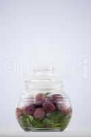 Close up of red olives in jar