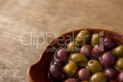 High angle view of olives with oil in container
