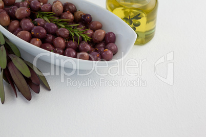 Close up of olives and rosemary with oil in jar