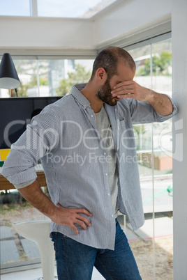 Tensed designer standing at studio