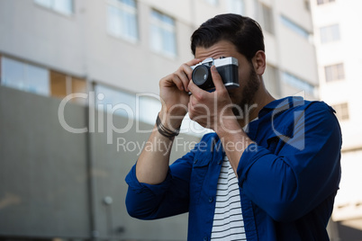 Young man photographing through camera