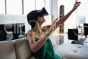 Woman using virtual reality simulator at office