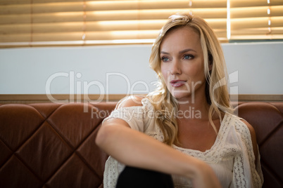 Woman sitting on sofa in restaurant