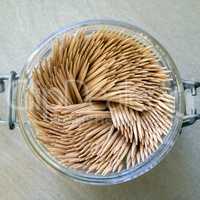 group of toothpicks in a glass jar
