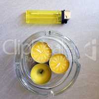 three little yellow aromatic candles with a yellow lighter