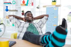 Male executive relaxing at his desk