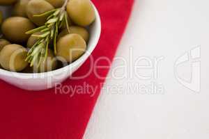 Cropped image of olives in bowl on napkin