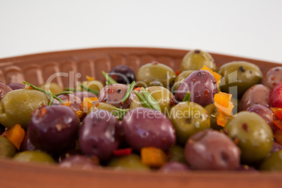 Close up of olives served with chili pepper