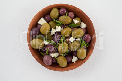 Olives with cheese and rosemary served in bowl