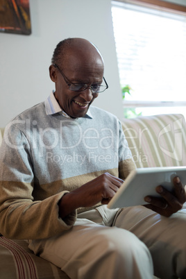 Happy senior man using tablet