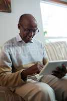 Happy senior man using tablet