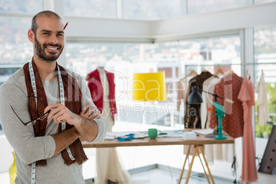 Portrait of smiling designer with arms crossed in workshop