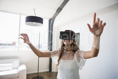 Smiling businesswoman wearing virtual reality simulator