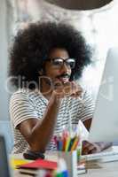 Man with curly hair using computer in office