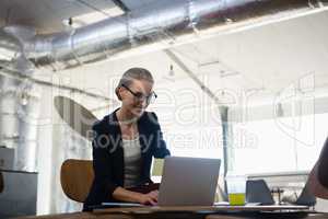 Young woman using laptop in office