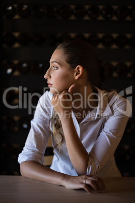 Thoughtful woman sitting at counter Thoughtful woman sitting at counter