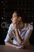 Thoughtful woman sitting at counter