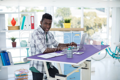 Executive working on laptop in office