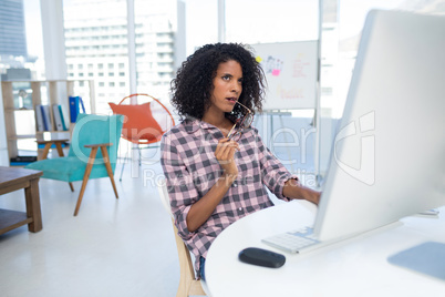 Female executive working on computer at desk