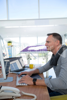 Male executive working at desk in the office