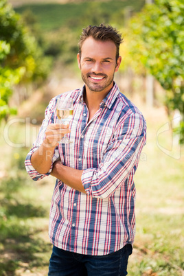 Portrait of young man holding wineglass