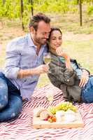 Smiling man with woman holding wineglass