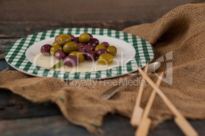 Close up of green and black olives served in plate