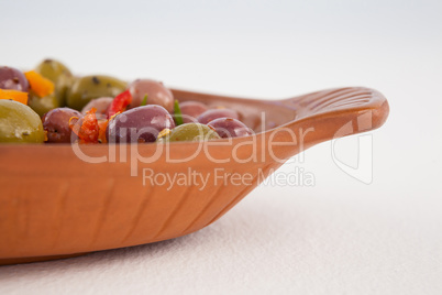 Cropped image of olives served in wooden container