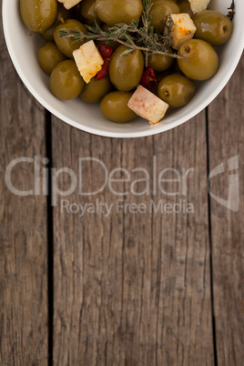 Overhead view of olives with cheese served in bowl