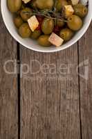 Overhead view of olives with cheese served in bowl