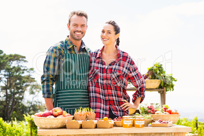 Portrait of smiling couple selling organic vegetables