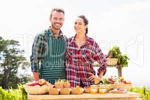 Portrait of smiling couple selling organic vegetables