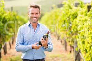 Portrait of man holding wine bottle