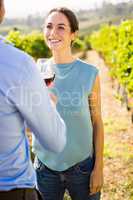 Smiling woman looking at man holding wineglass