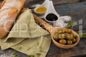 Close up of olive oil by bread on table