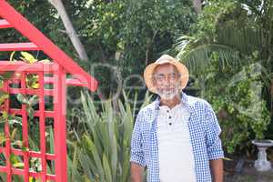 Portrait of man standing by metallic structure