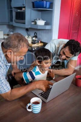 Happy father and grandfather looking at boy