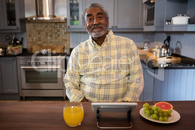 Portrait of smiling senior man in kitchen