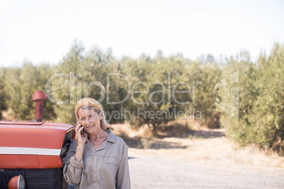 Woman talking on mobile phone in olive farm