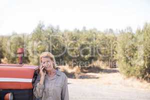 Woman talking on mobile phone in olive farm