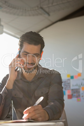 Man talking on phone while working at office