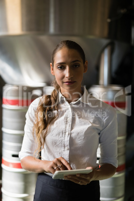 Waitress using digital tablet in bar